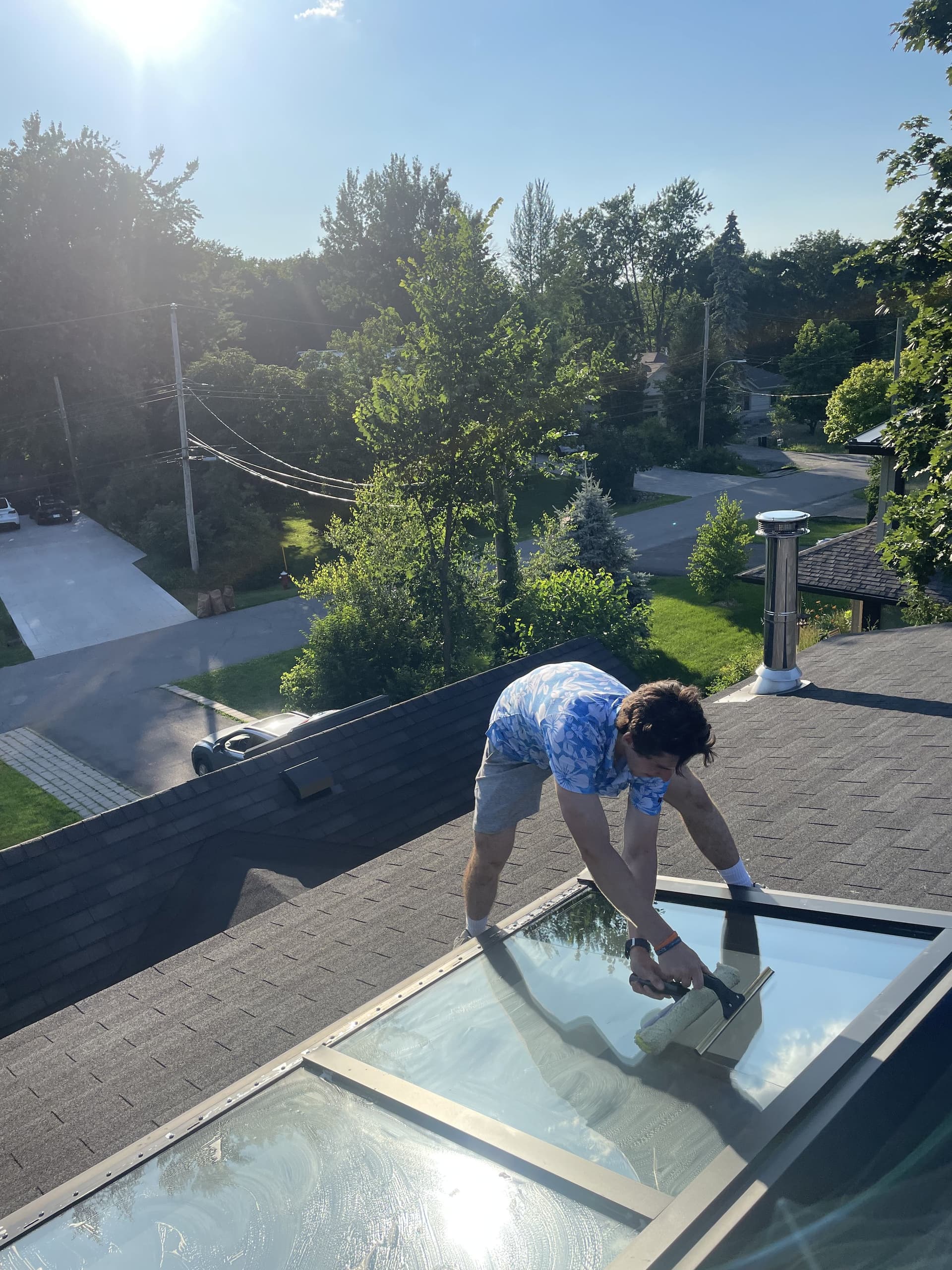 JAB team member cleaning a skylight on a Montreal rooftop